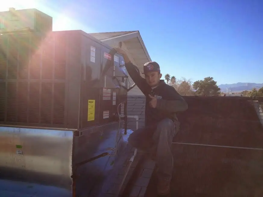 HVAC technician performing HVAC Inspection on a rooftop unit in Annville